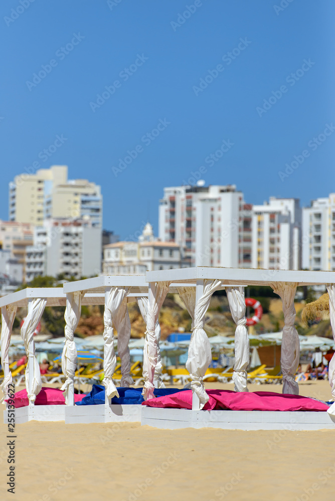 some beds and sunlounger in a beach club some beds and sunlounger in a beach club