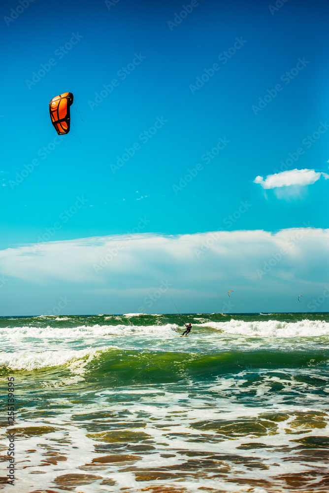 Silhouette of windsurfer racing breaking wave Silhouette of windsurfer racing breaking wave