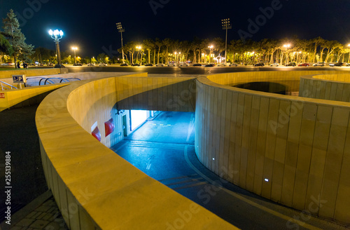 Entry and exit from the underground car parking. Night view