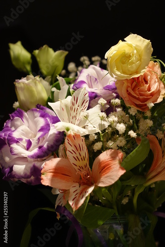 Beautiful wedding bouquet composed of different flowers on a black background.