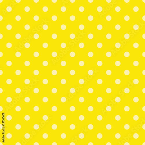 Light yellow polka dots on bright yellow background. Decorative seamless pattern