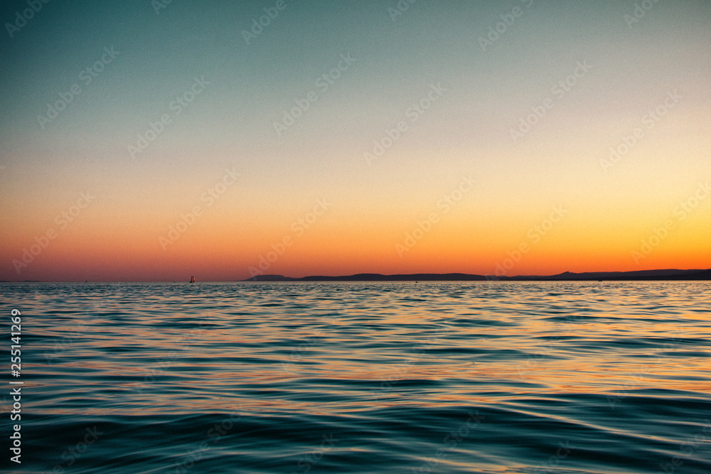 Silky smooth water with sunset in background