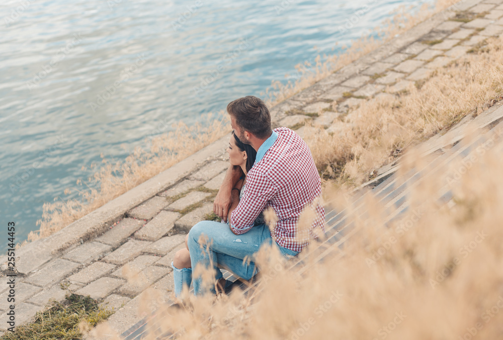 Fototapeta premium Beautiful couple enjoying time together outdoor, handsome young man hugging his girlfriend.