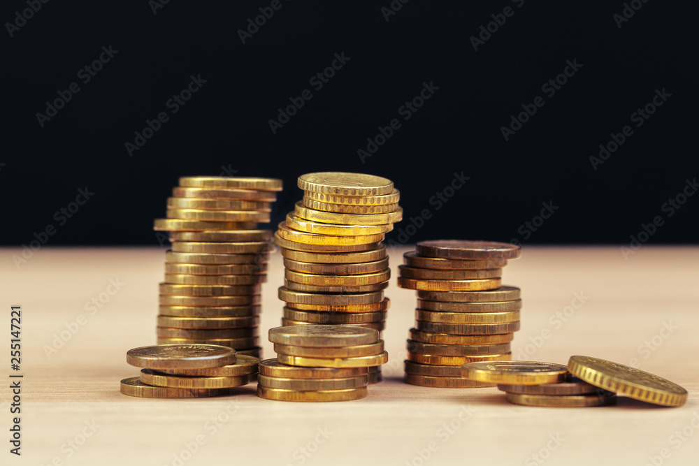 piles of coins on working table piles of coins on working table
