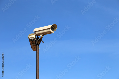 Outdoor surveillance cameras on a pole isolated on clear blue sky. Cctv camera, concept for security, antiterrorism and protection from crime