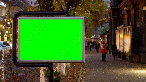 Wallpaper Mural 4K Time Lapse video. Big billboard with green screen against the background of walking blurred people in autumn city. Torontodigital.ca
