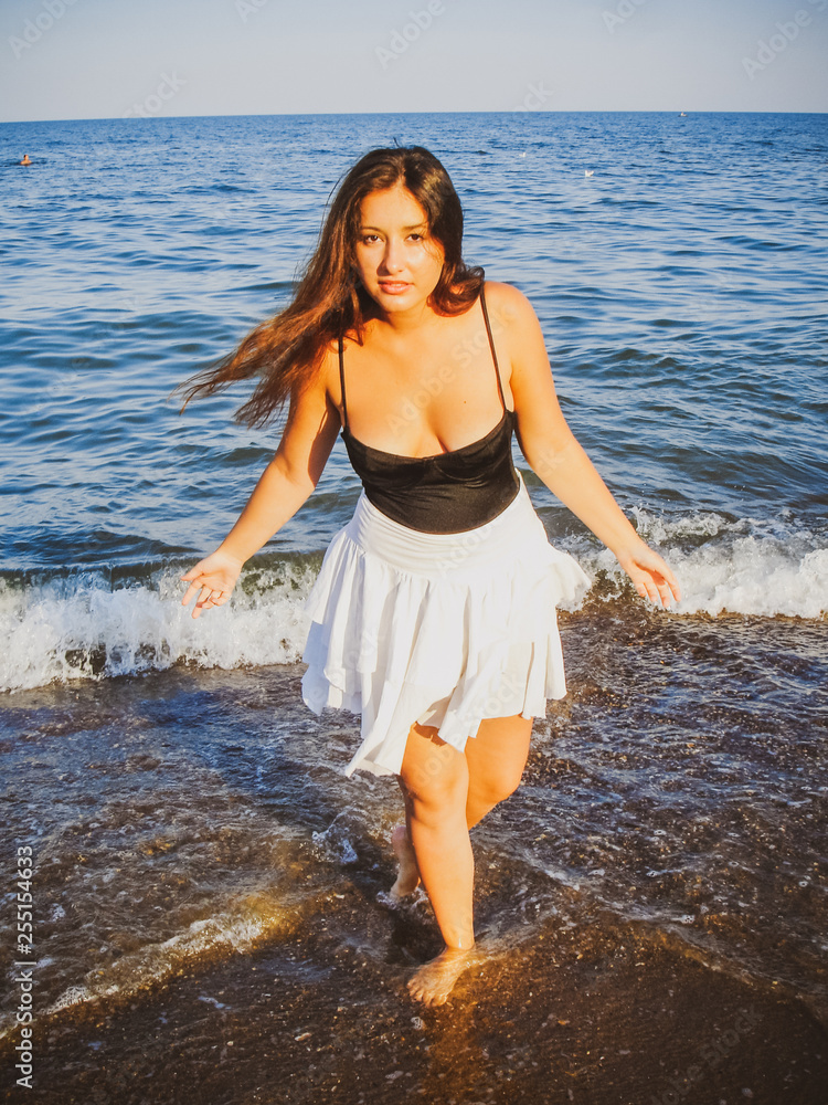 Young simple plus size indian girl in swimwear enjoying vacation, woman with xl figure, pretty girl, vinatge texture 