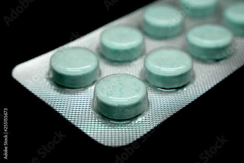 Blister pill medicine isolated on black background.