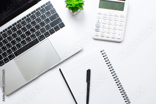 Business woman using calculator and laptop on white desk, Accounting concept, Top view.