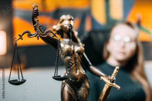 scales of justice in the office. The concept of jurisprudence, a young woman judge, lawyer, prosecutor. © velimir