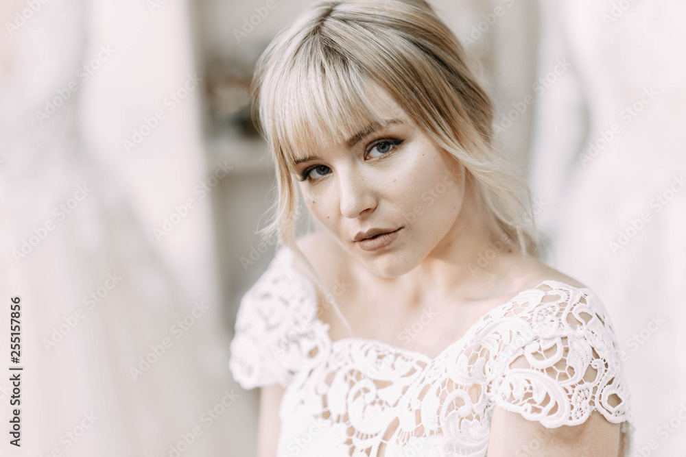 Portrait of a beautiful blonde bride in a lace wedding dress. Portrait of a beautiful blonde bride in a lace wedding dress.