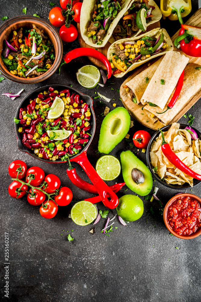 Cinco de Mayo food.Mexican food concept background with taco, quesadilla, burrito, chili, salsa sauce, hot pepper, lime. Black concrete background top view copy space