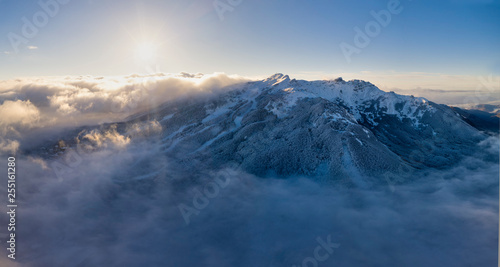 Panoramic aerial view of La Nuda mountain and Cerreto Laghi town in winter season at sunrise, municipality of Ventasso, Reggio Emilia province, Emilia Romagna, Italy, Europe