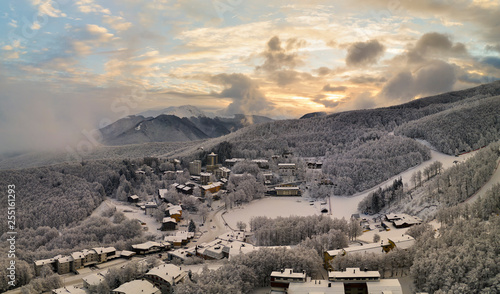 Panoramic aerial view of Cerreto Laghi town in winter season at sunrise, municipality of Ventasso, Reggio Emilia province, Emilia Romagna, Italy, Europe