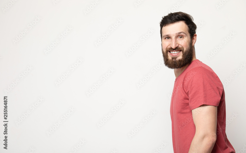 Portrait of young amazed bearded man isolated on gray background Portrait of young amazed bearded man isolated on gray background