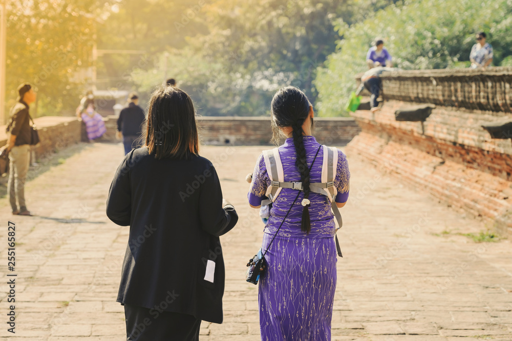 Fototapeta premium Backview of female tourists at ancient Pa Hto Taw Gyi Pagoda ruins at Mingun city near Mandalay, Myanmar.