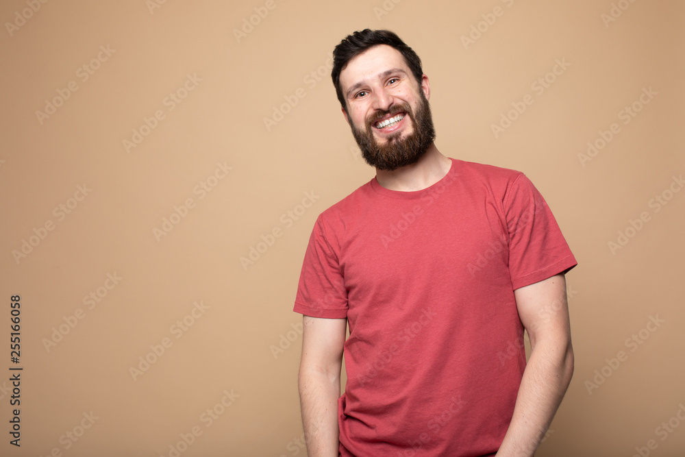Young bearded man laughing, studio shot. Young bearded man laughing, studio shot.
