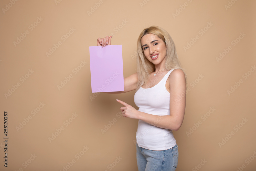 young smiling woman holding a blank sheet of paper for advertising young smiling woman holding a blank sheet of paper for advertising