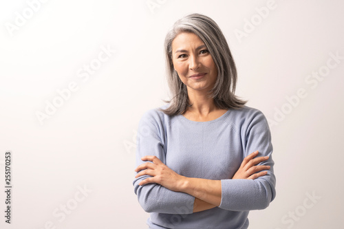 Obraz na plátně Beautiful grey-haired woman with crossed arms