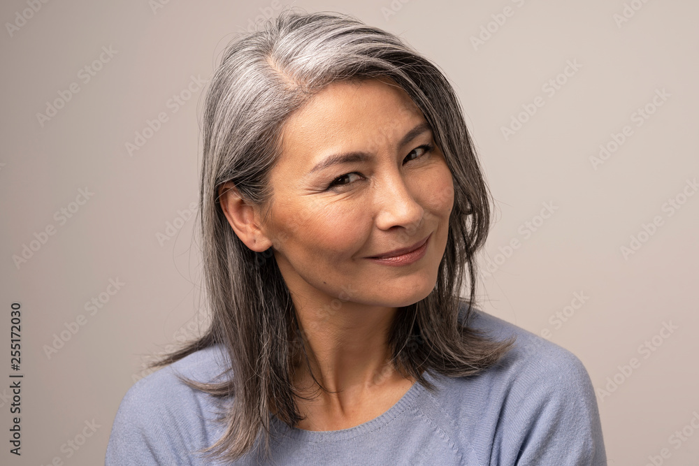 Charming Asian mature woman smiles at camera Charming Asian mature woman smiles at camera