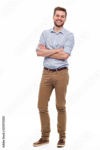 Fototapeta Full length portrait of young man standing on white background