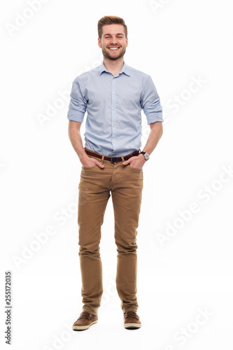 Full length portrait of young man standing on white background