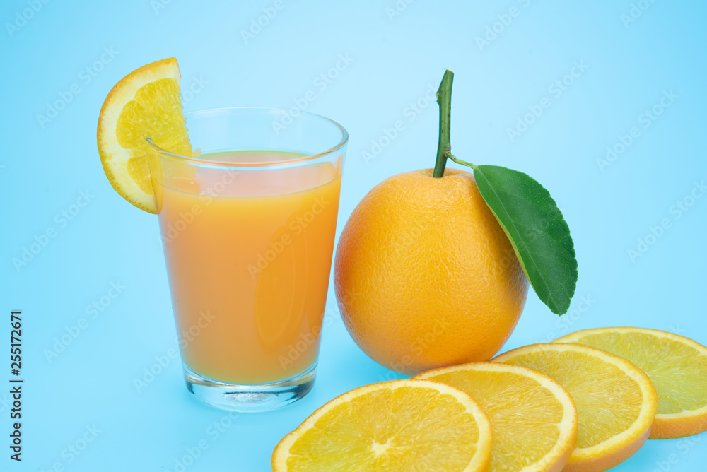 Orange juice and oranges with leaves Orange juice and oranges with leaves