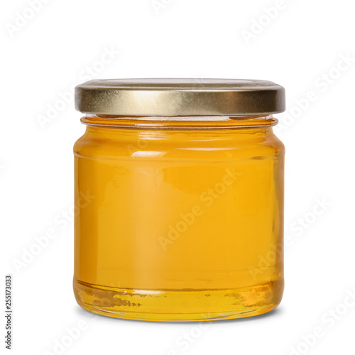 Glass jar full of sweet honey isolated on white background photo