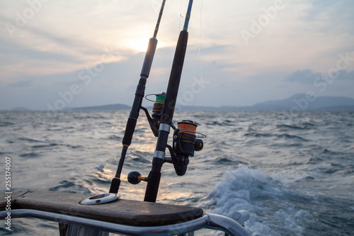 trolling rods and reels for sea fishing on a boat against the sea