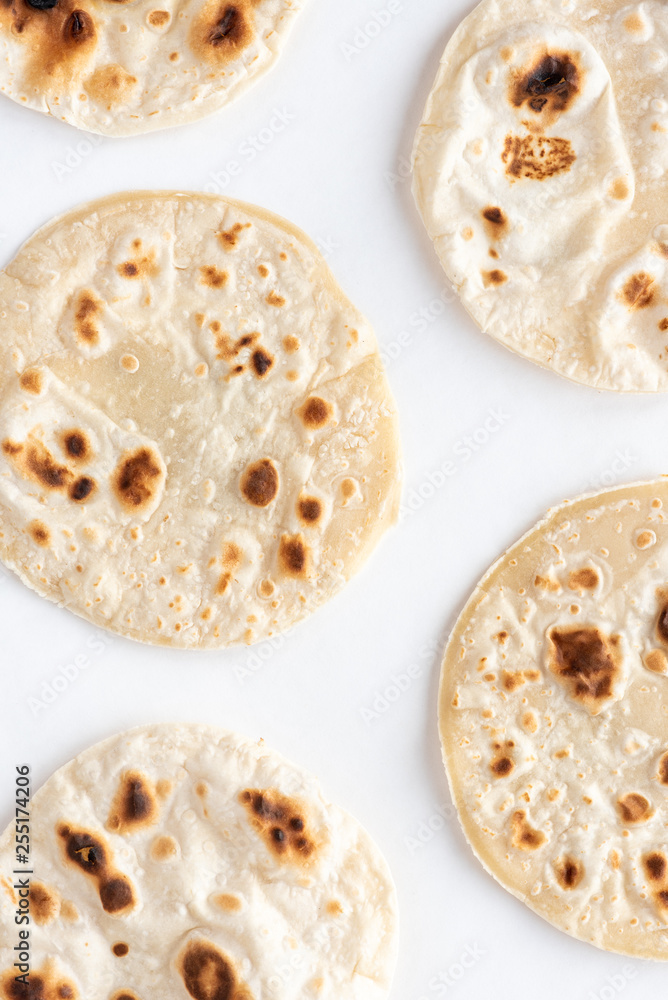 Flat bread on white background, top view.