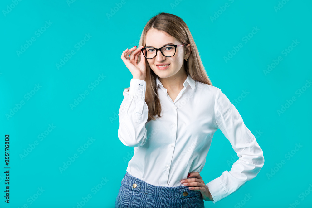Blank for advertising. Portrait young caucasian woman worker teacher coach mentor in white shirt office style business lady leader advertising glasses eyesight blue isolated color background Blank for advertising. Portrait young caucasian woman worker teacher coach mentor in white shirt office style business lady leader advertising glasses eyesight blue isolated color background