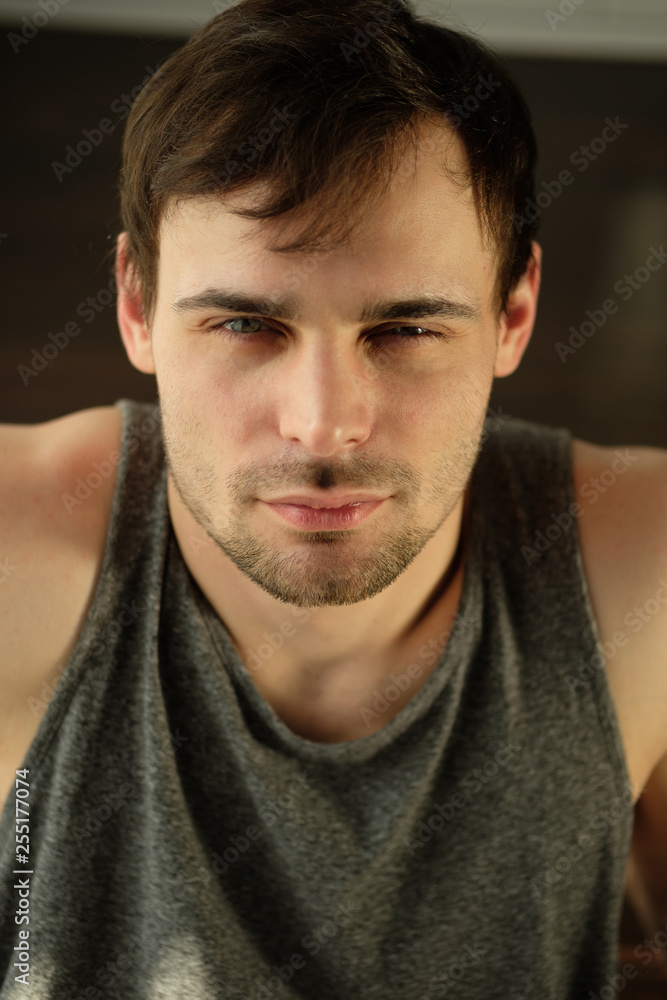 Fototapeta premium Portrait of a handsome man doing exercises at home