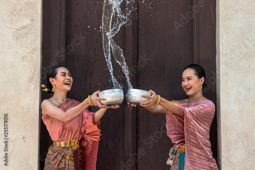 Thailand culture. Thai girls and thai women playing splashing water during with Thai Traditional costume in the temple of Ayutthaya Thailand festival Songkran festival.