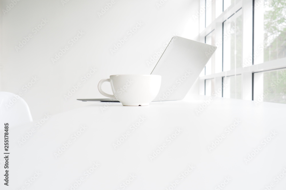 Notebooks and white coffee mugs placed next to the window on the desk with the chair on white background Notebooks and white coffee mugs placed next to the window on the desk with the chair on white background