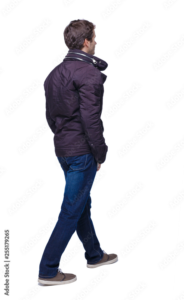 Side view of going handsome man in jeans and jacket. Side view of going handsome man in jeans and jacket.