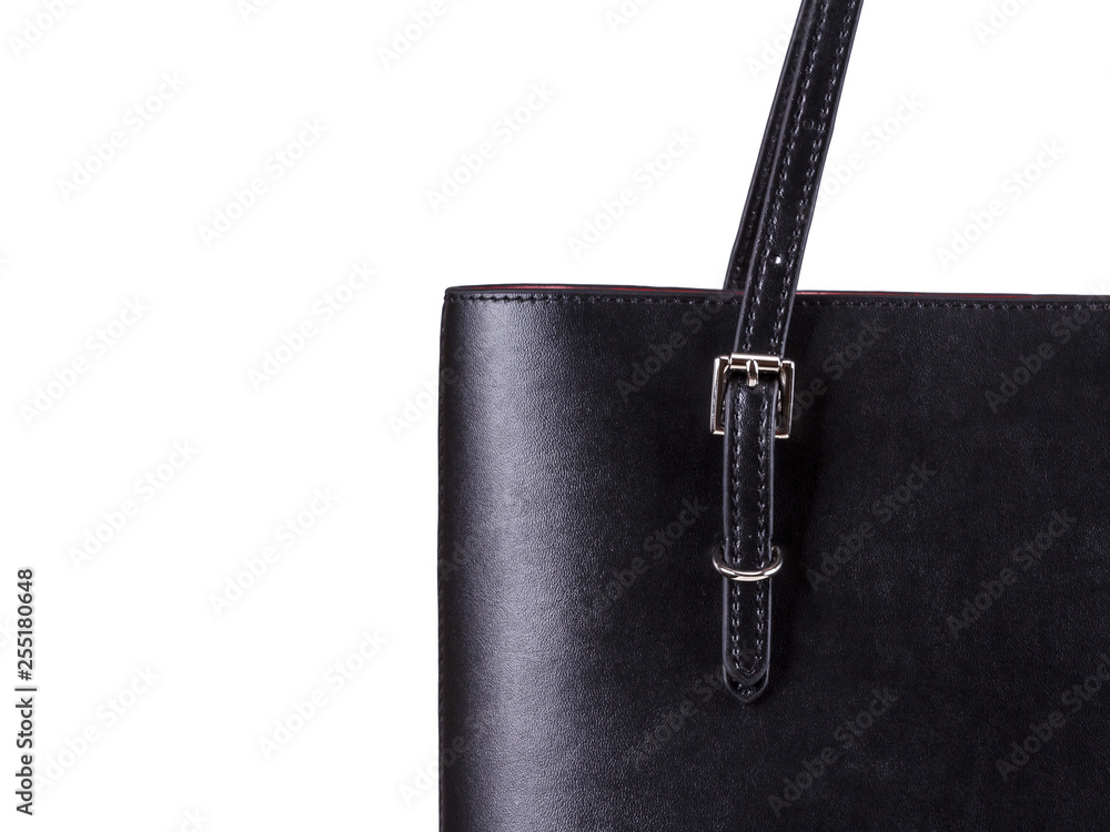 Close-up part of black bag for women made of black leather on a white Close-up part of black bag for women made of black leather on a white