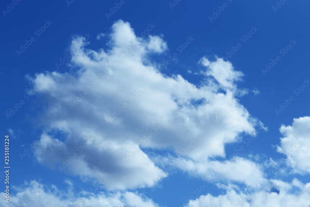 Fototapeta premium Fluffy white clouds on the blue color sky background