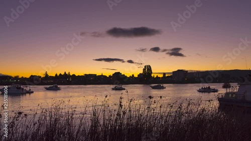 Time lapse at sunset on the riverside Callecalle in the city of Valdivia. Boats await the nautical parade for the anniversary of the city photo