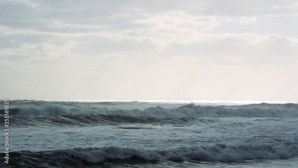Pelicans flying over ocean waves along shoreline Pelicans flying over ocean waves along shoreline