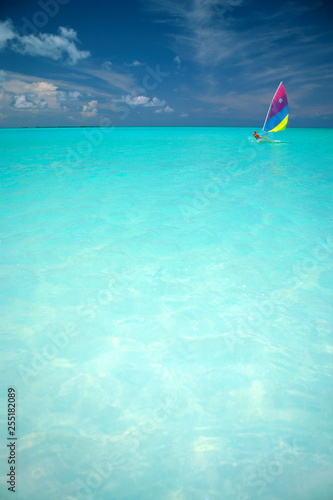 Woman sailing Sunfish Sailboat, Abacos, Bahamas photo