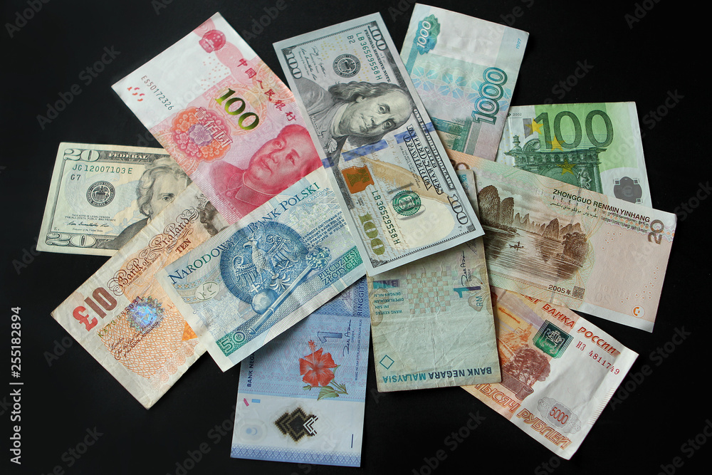 Closeup of banknotes of different states on a dark background