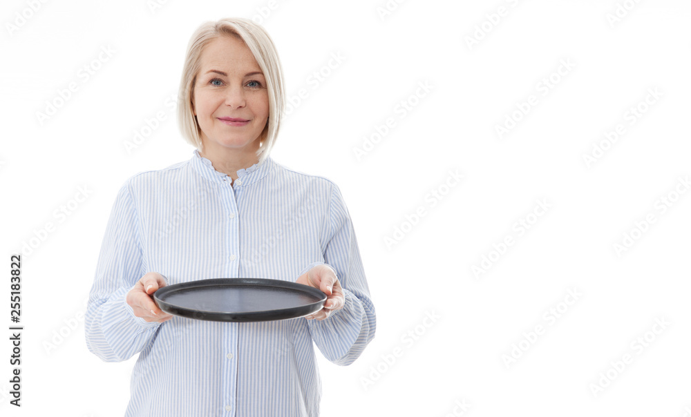 Kitchen woman gives empty black plate for your advertising products isolated on white background. Mock up for use Kitchen woman gives empty black plate for your advertising products isolated on white background. Mock up for use
