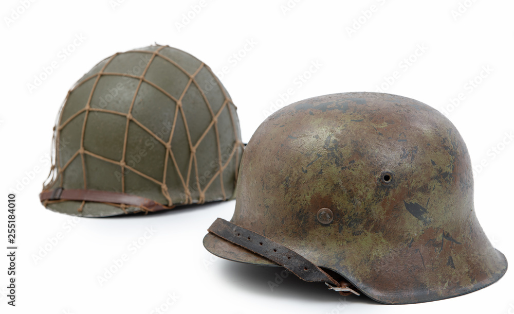 German and U.S  World War Two military helmets, battle of Normandy 1944 - obrazy, fototapety, plakaty 