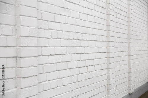 Blank ad space on a white brick wall in the street outside