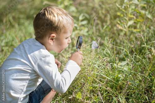 Young researcher explores nature with a magnifying glass