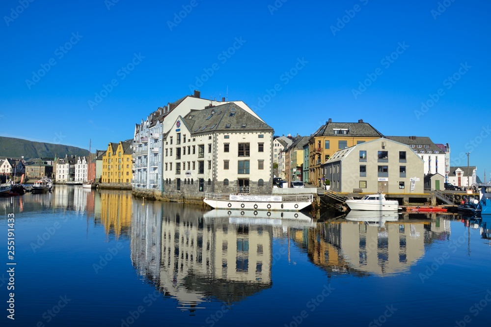 Stunning water reflection of the Art Nouveau architecture over a water canal of Alesund, Norway.
