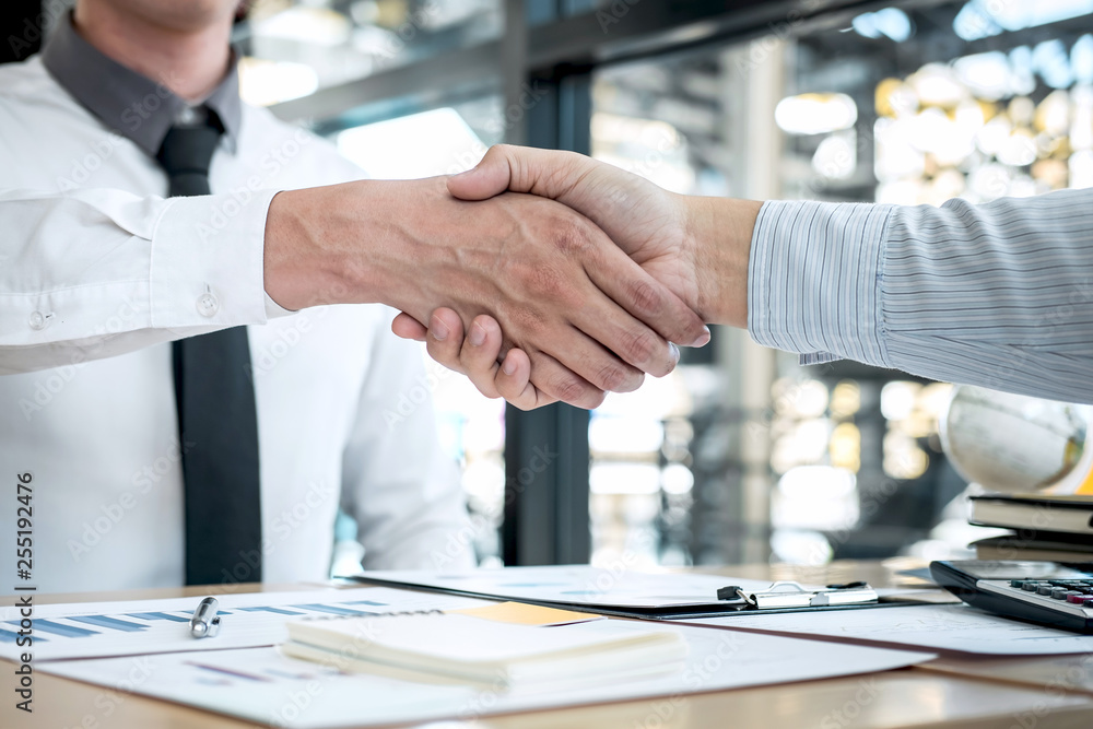 Finishing up a conversation after collaboration, handshake of two business people after contract agreement to become a partner, collaborative teamwork Finishing up a conversation after collaboration, handshake of two business people after contract agreement to become a partner, collaborative teamwork