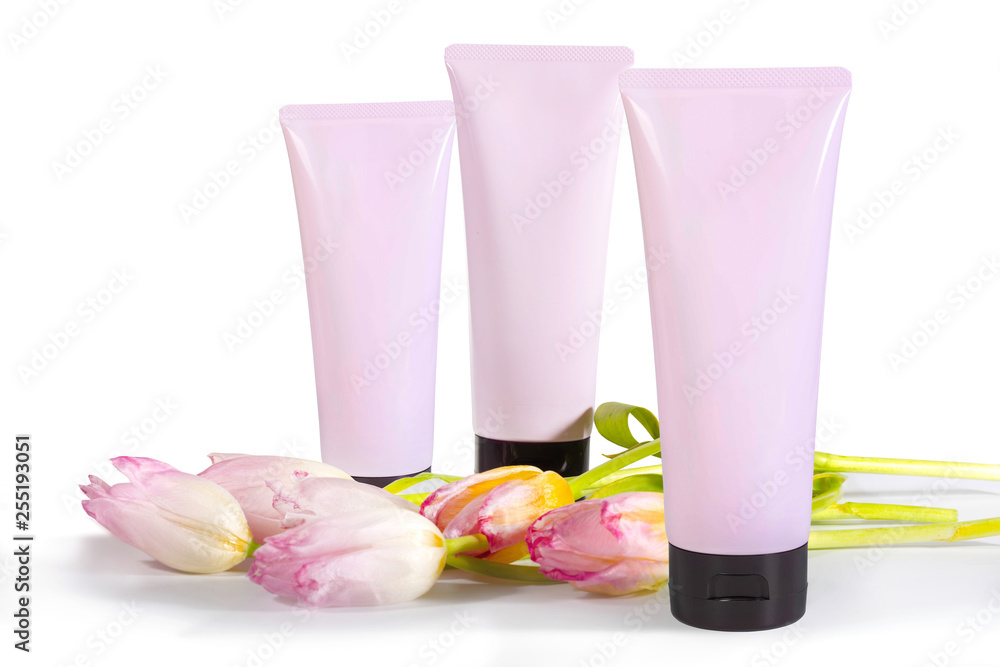 Natural organic cosmetic and flowers on a white background. empty tubes for branding. Natural organic cosmetic and flowers on a white background. empty tubes for branding.