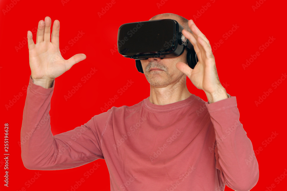 Close-up of a man in a pink T-shirt with glasses of virtual reality. Close-up of a man in a pink T-shirt with glasses of virtual reality.