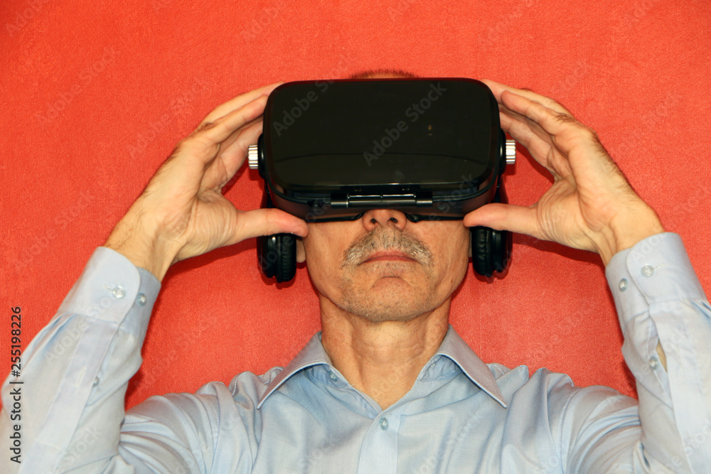 The man in a virtual reality glasses gesturing The man in a virtual reality glasses gesturing